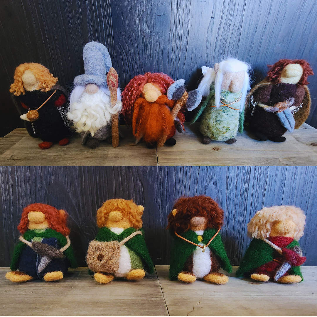 Two-row display of the needle-felted Fellowship: Gandalf, Boromir, Gimli, Legolas, and Aragorn in the top row, and the four hobbits in the bottom row.