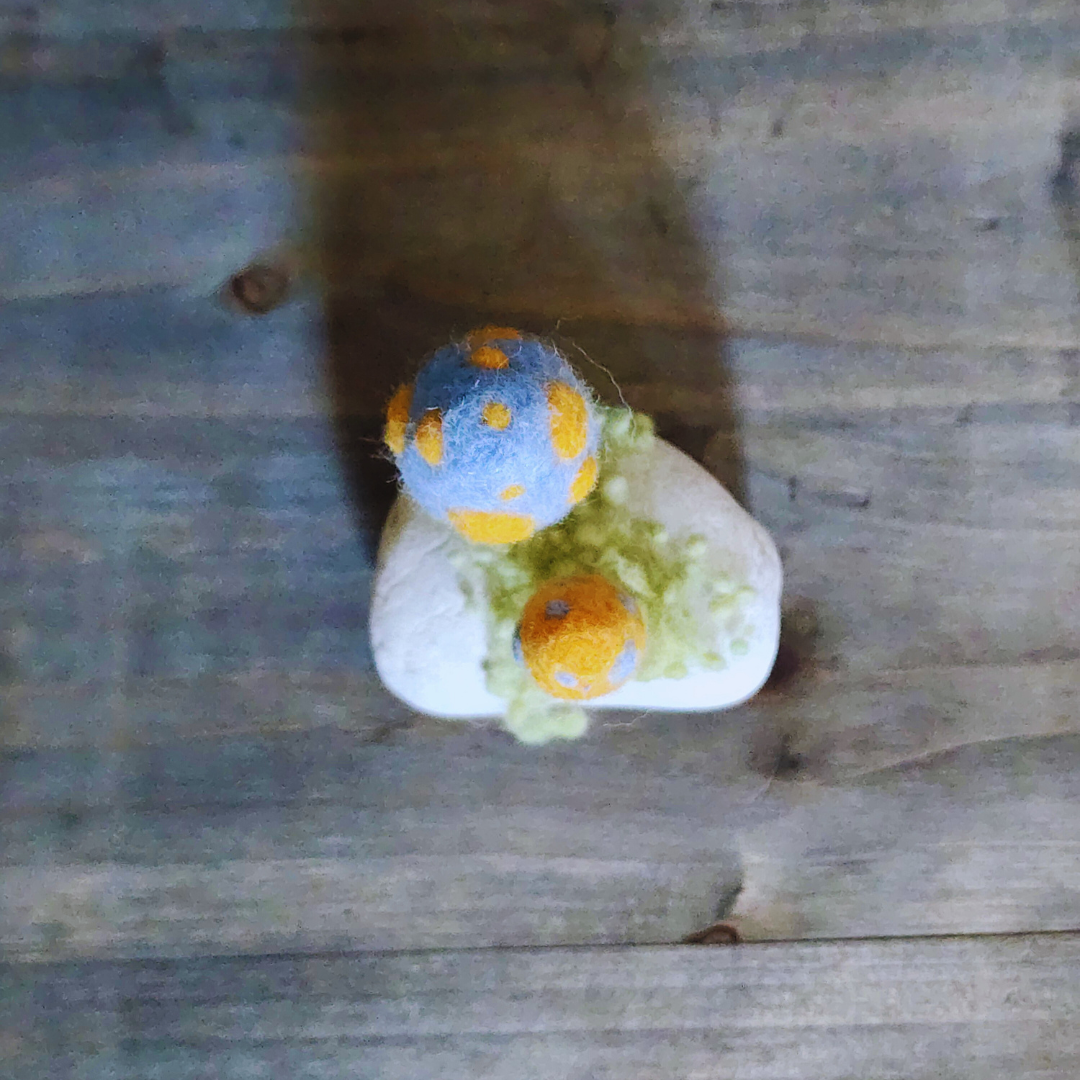 Handmade Felt Magic Mushrooms on White Granite Stone