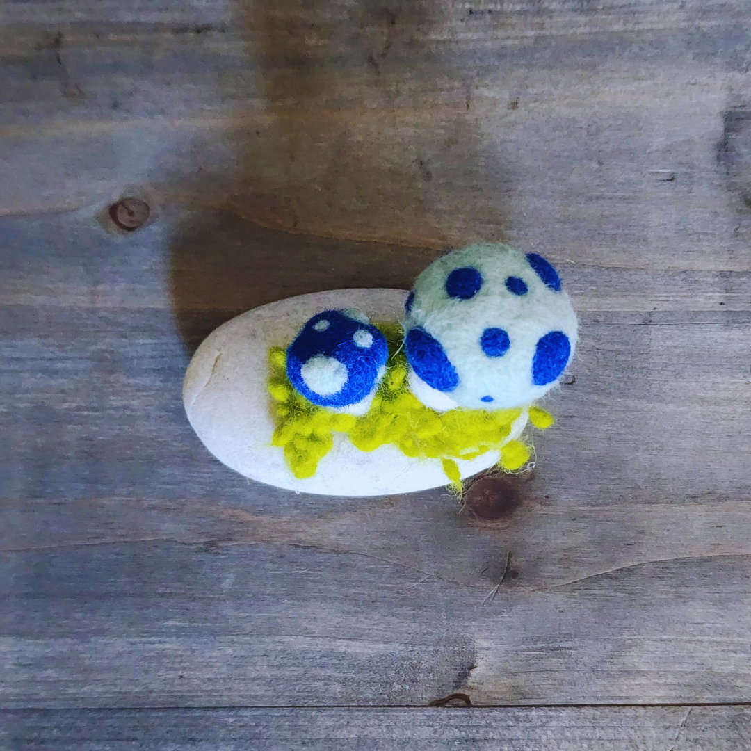 Handmade Felt Magic Mushrooms on White Granite Stone