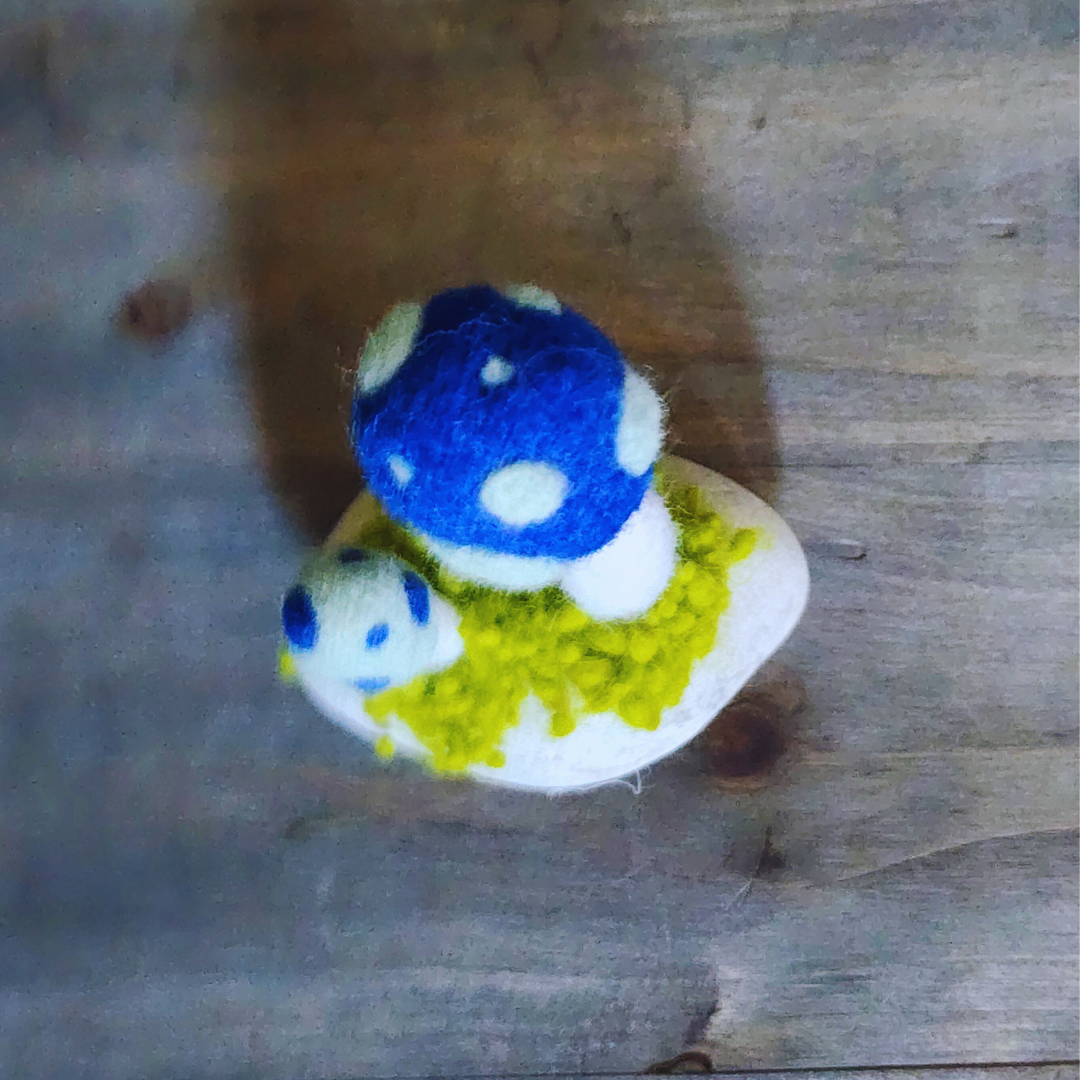 Handmade Felt Magic Mushrooms on White Granite Stone