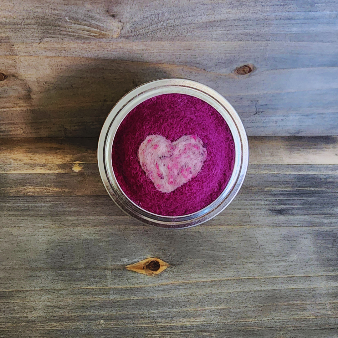 A top-down view of the magenta needle-felted base with a textured pink heart felted in the center.
