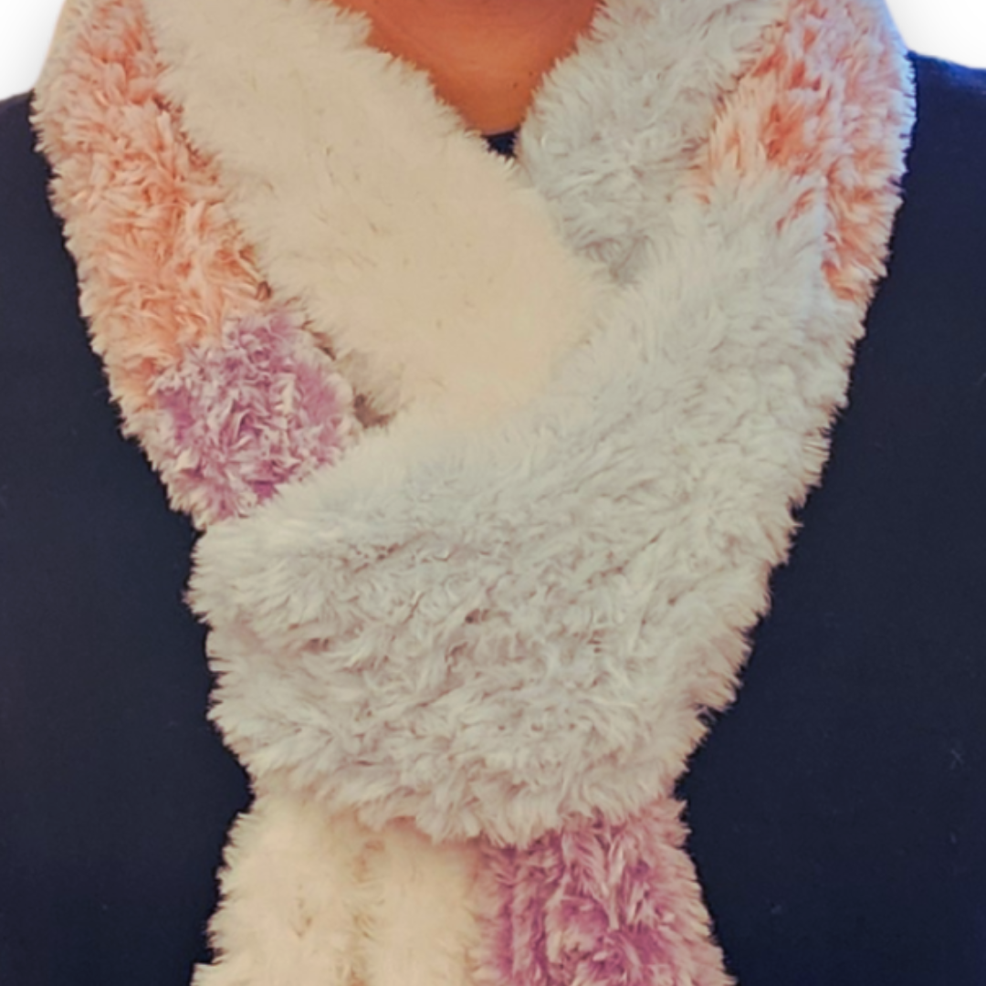 A close-up view of the tricolor faux fur scarf, featuring soft vertical stripes of pastel pink, white, and purple, knotted around the neck.