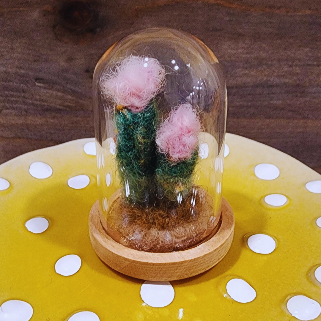 A handmade needle-felted Flowering Cactus terrarium with two pink felt blooms in a glass dome.