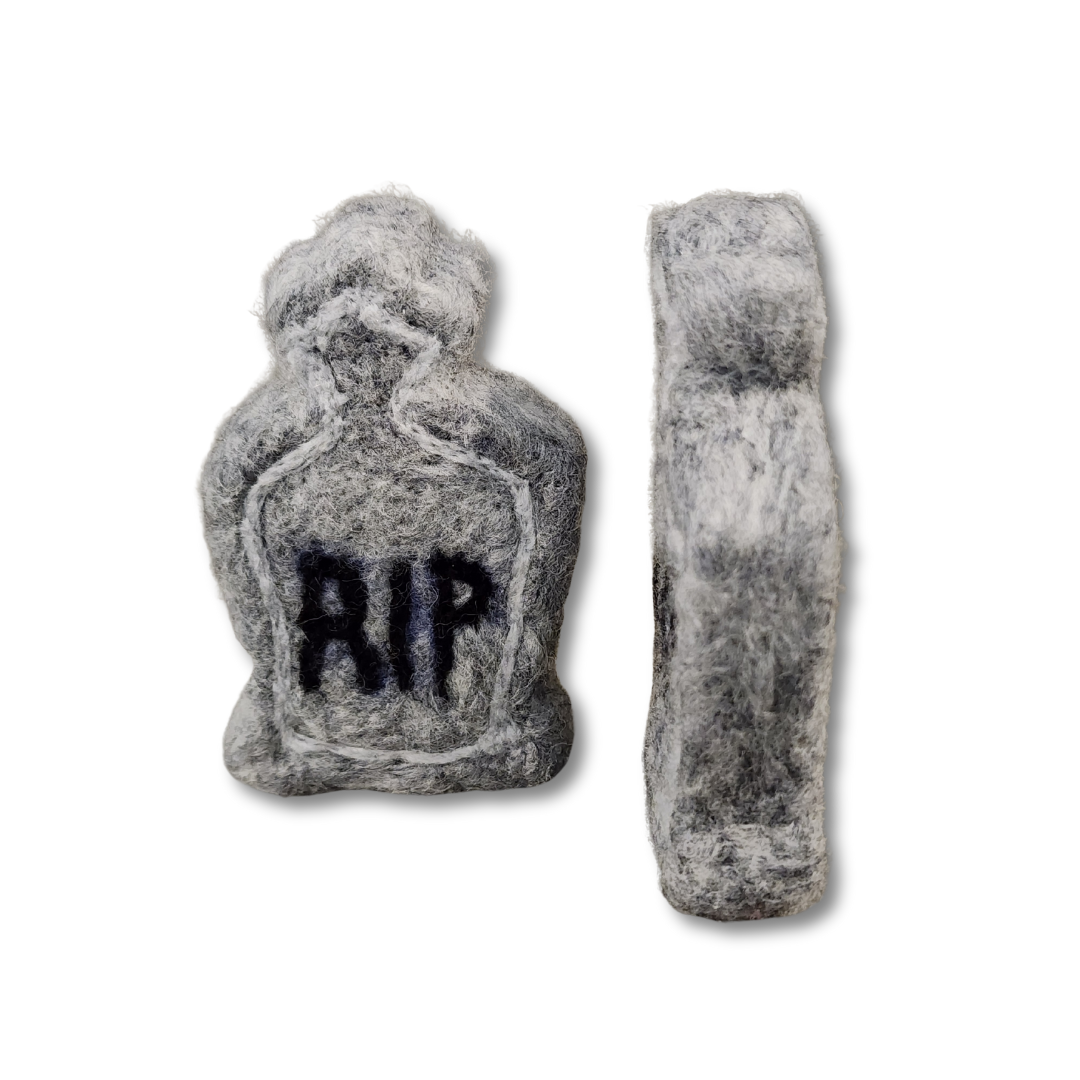 A handmade felted tombstone figurine in gray with a black "RIP" inscription, shown from the front and from the side, demonstrating its height and thickness against a white background.