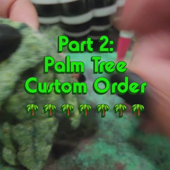 Part 2 of the custom order process: footage showing the needle-felting of the green fronds and coconuts, attaching the trunk to the stone base, and adding the wool nepps to create the sand effect.